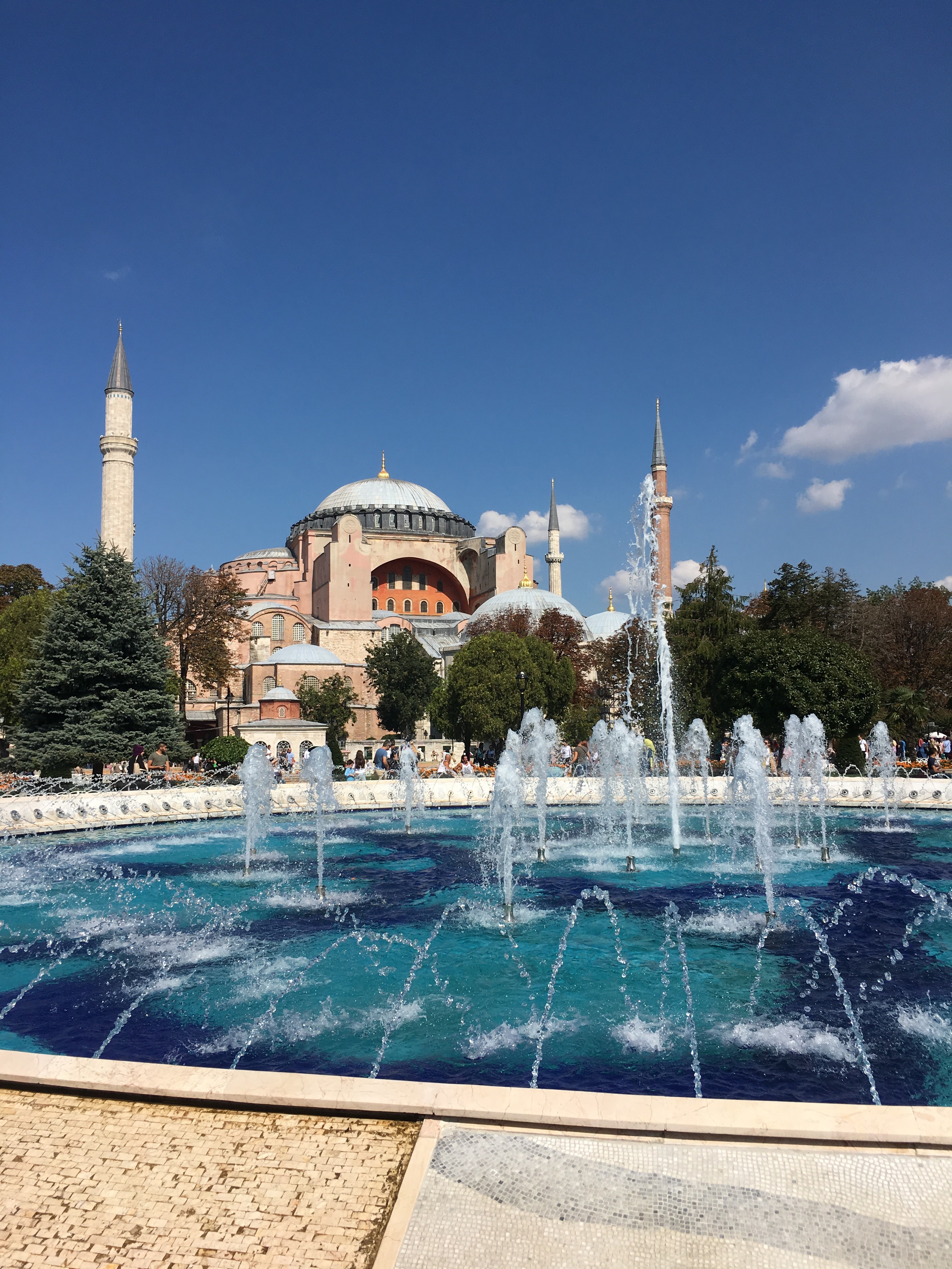 fountain with building in the background during daytime