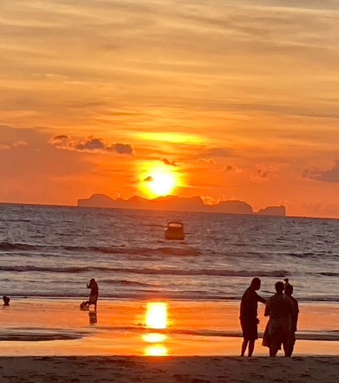 A beautiful golden sunset over the endless ocean on the beach.