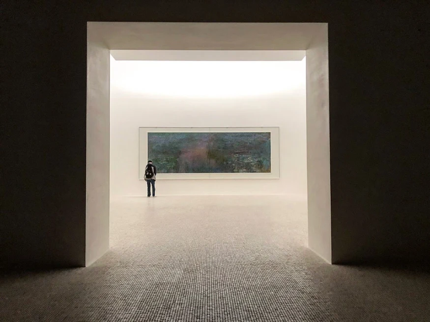 A man looking at a large painting in the Chichu Art Museum.