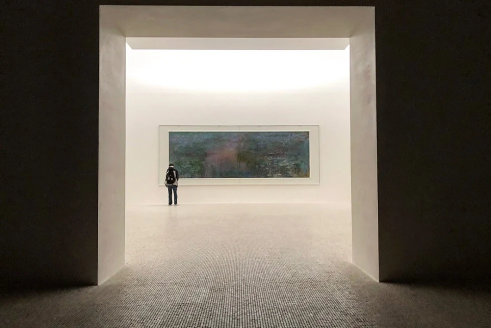 A man looking at a large painting in the Chichu Art Museum.