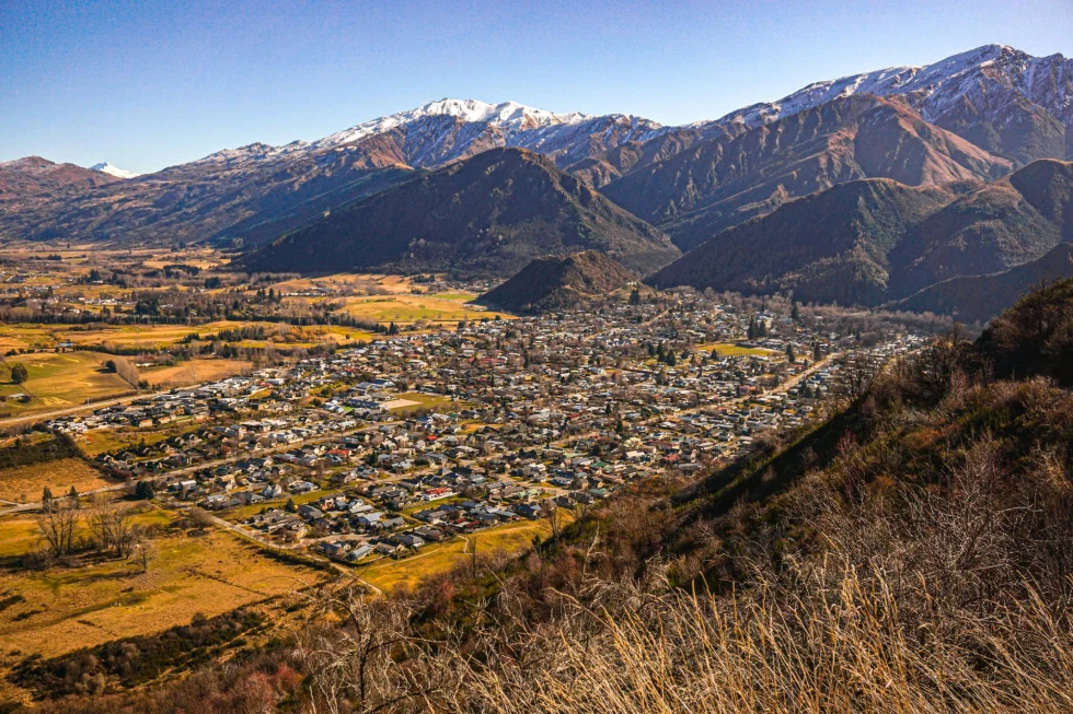 a town in a valley at the base of mountain range