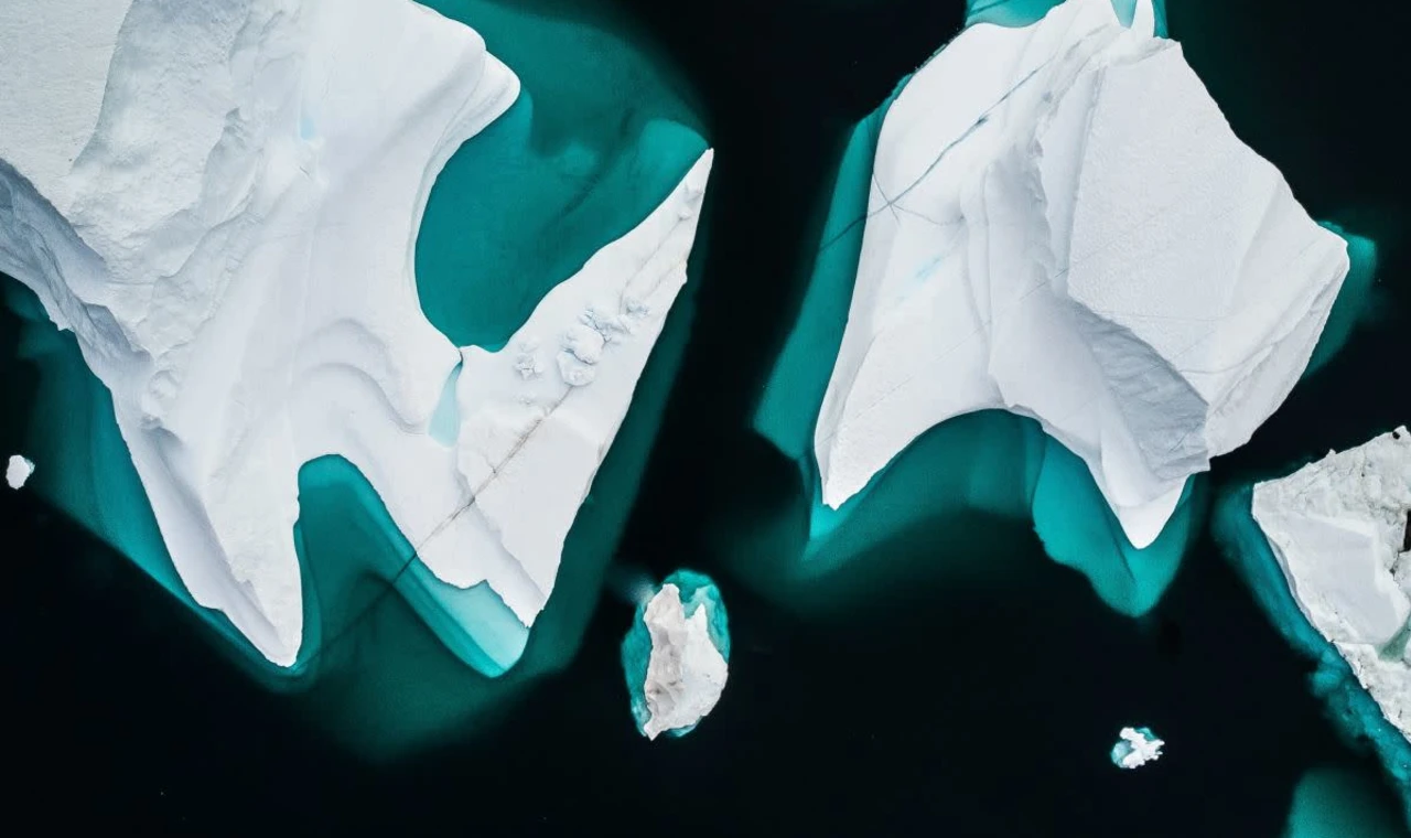 Aerial view of multiple icebergs in the water. 
