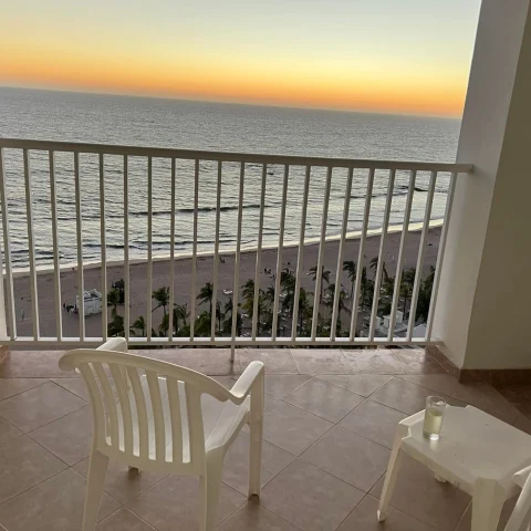 A picture of the sunset over the ocean from a white balcony at the Hotel Riu Mazatlan, Mexico.