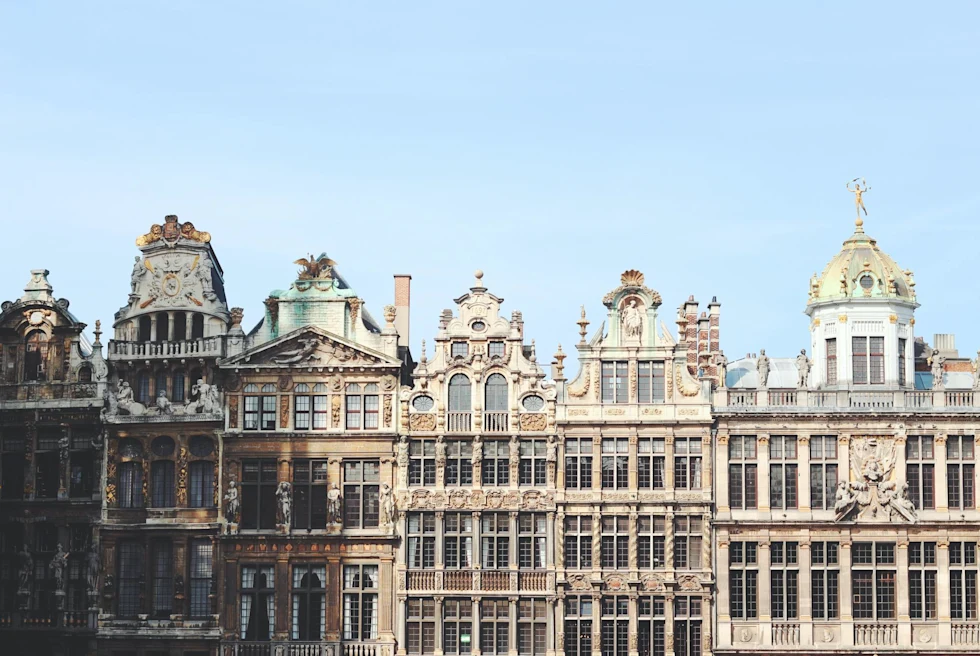 facade of a row of ornate buildings with varied rootops