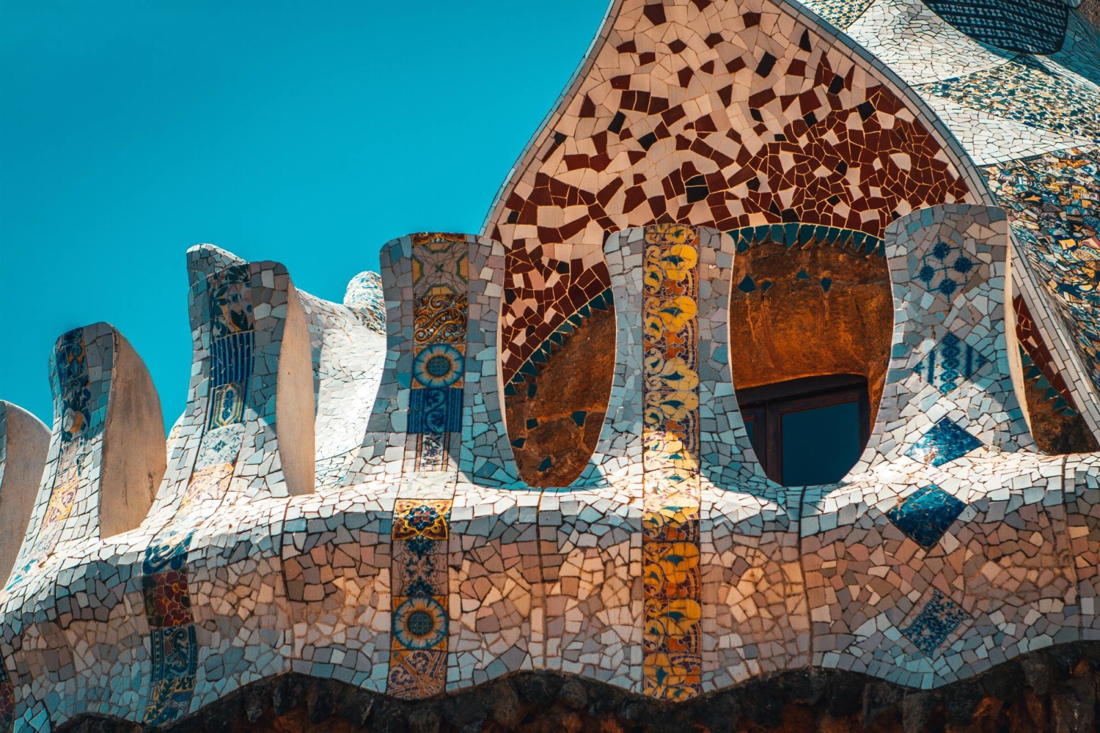 Close up of colorful mosaic and organic shapes of Antoni Gaudi's work at Park Guell in Barcelona.