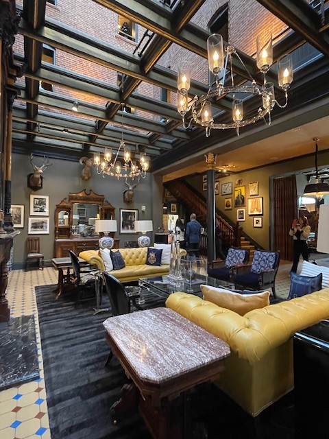 A lobby with yellow couches, something you can see while in Aspen Colorado for New Years.