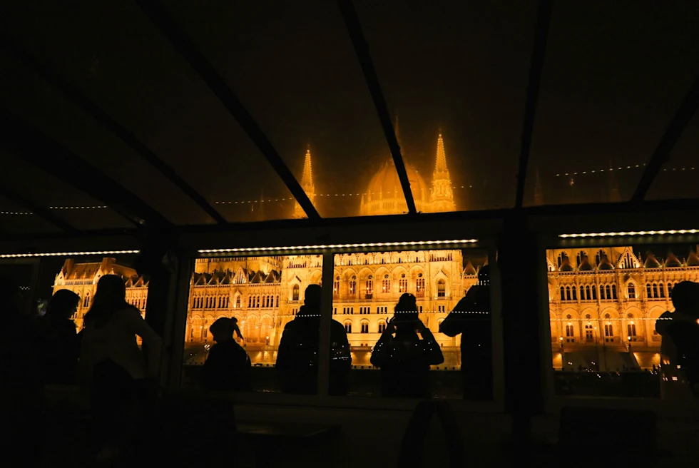 palace lit up at night through a restaurant window