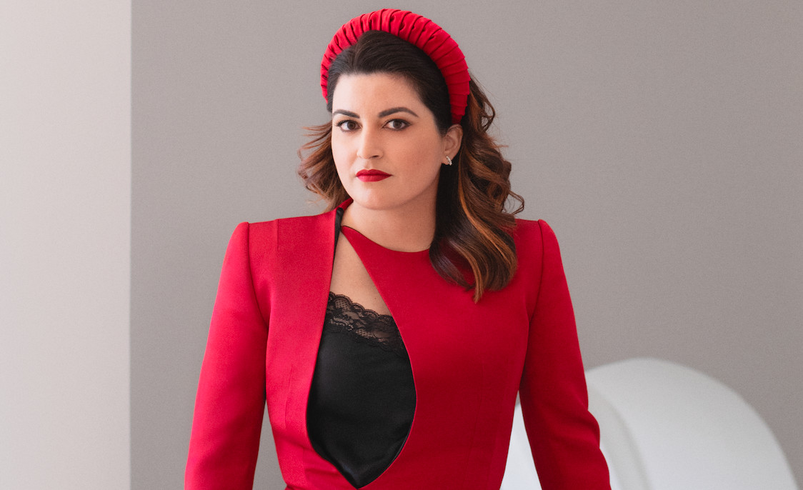 a woman in a black shirt and red jacket wars a red headband