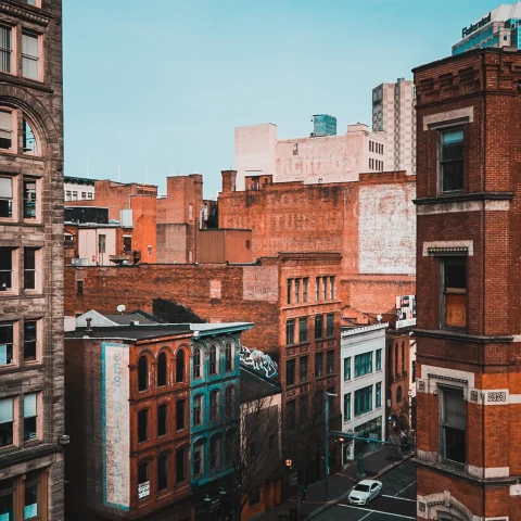 Orange and white buildings with the street and a blue sky