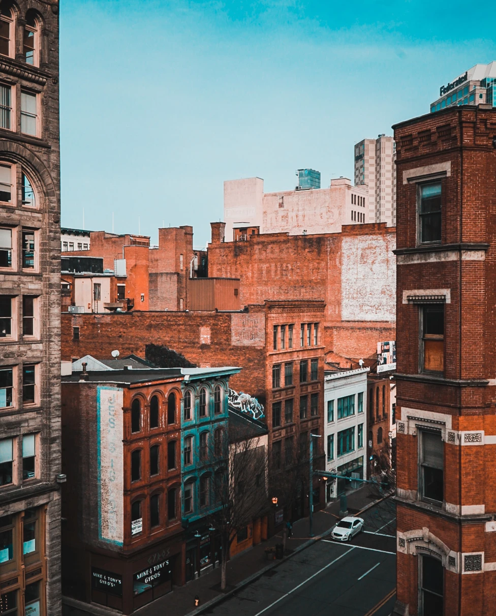 Orange and white buildings with the street and a blue sky