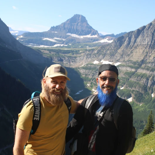 Travel Advisor Cesar Monell with a friend in front of a snowy mountain.