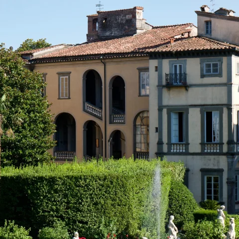 garden with fountain, statues and hedges in Italian village