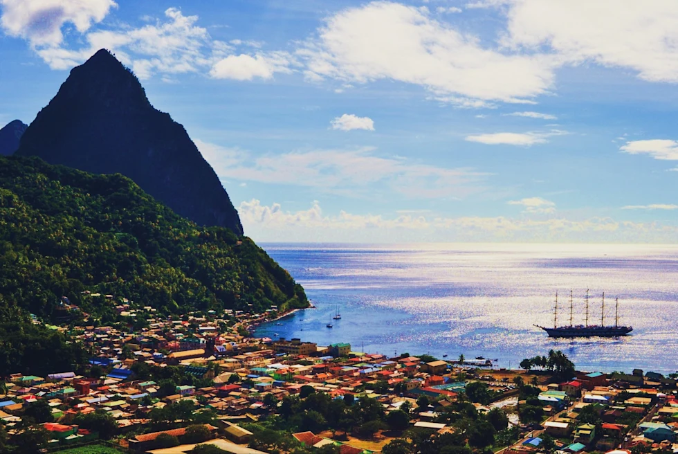 portside city near a large mountain jutting out of the sea