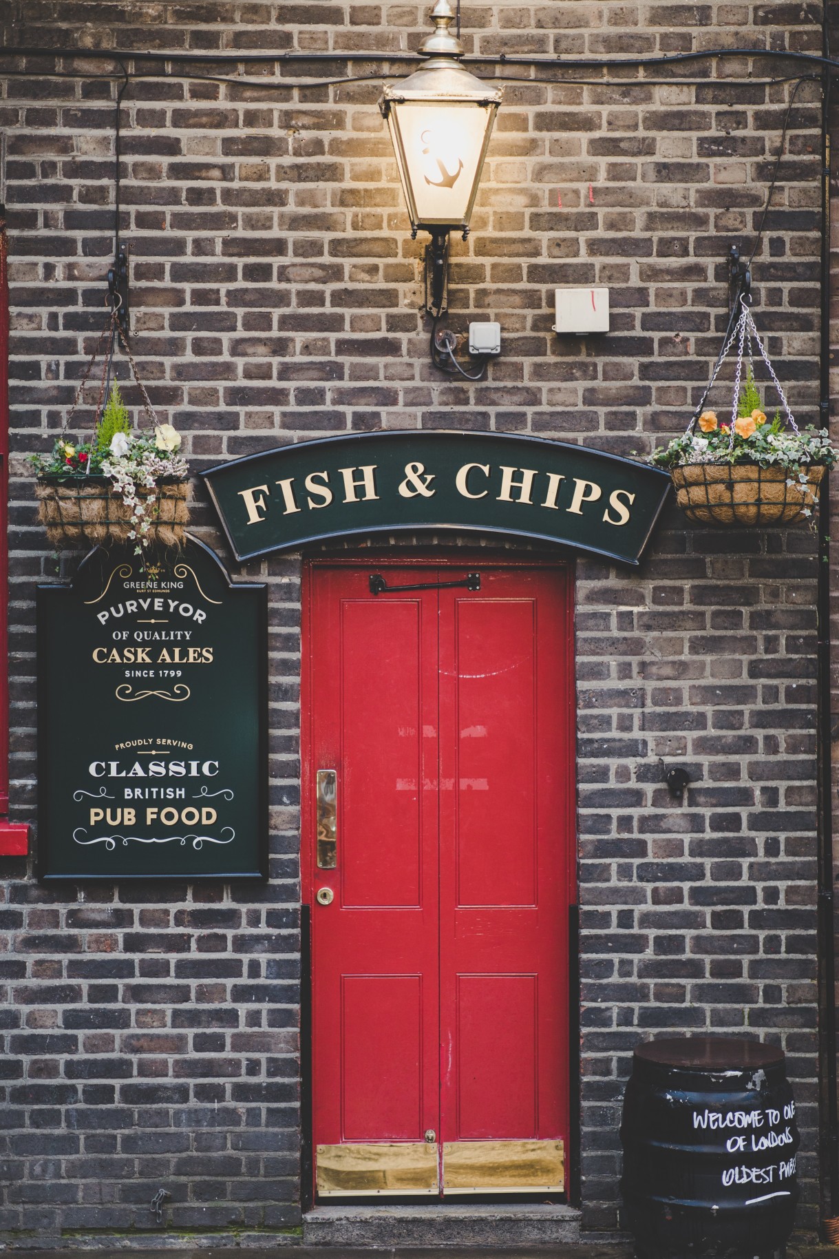 Red door with a sign that says "fish and chips."