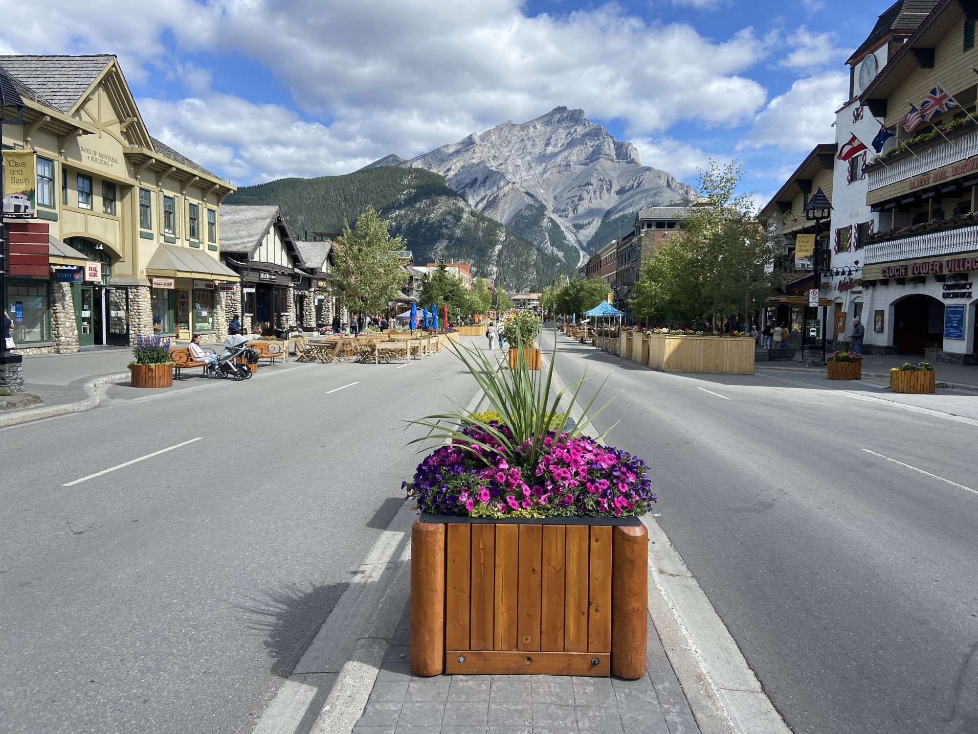 Street with buildings on the side and mountains at the back.