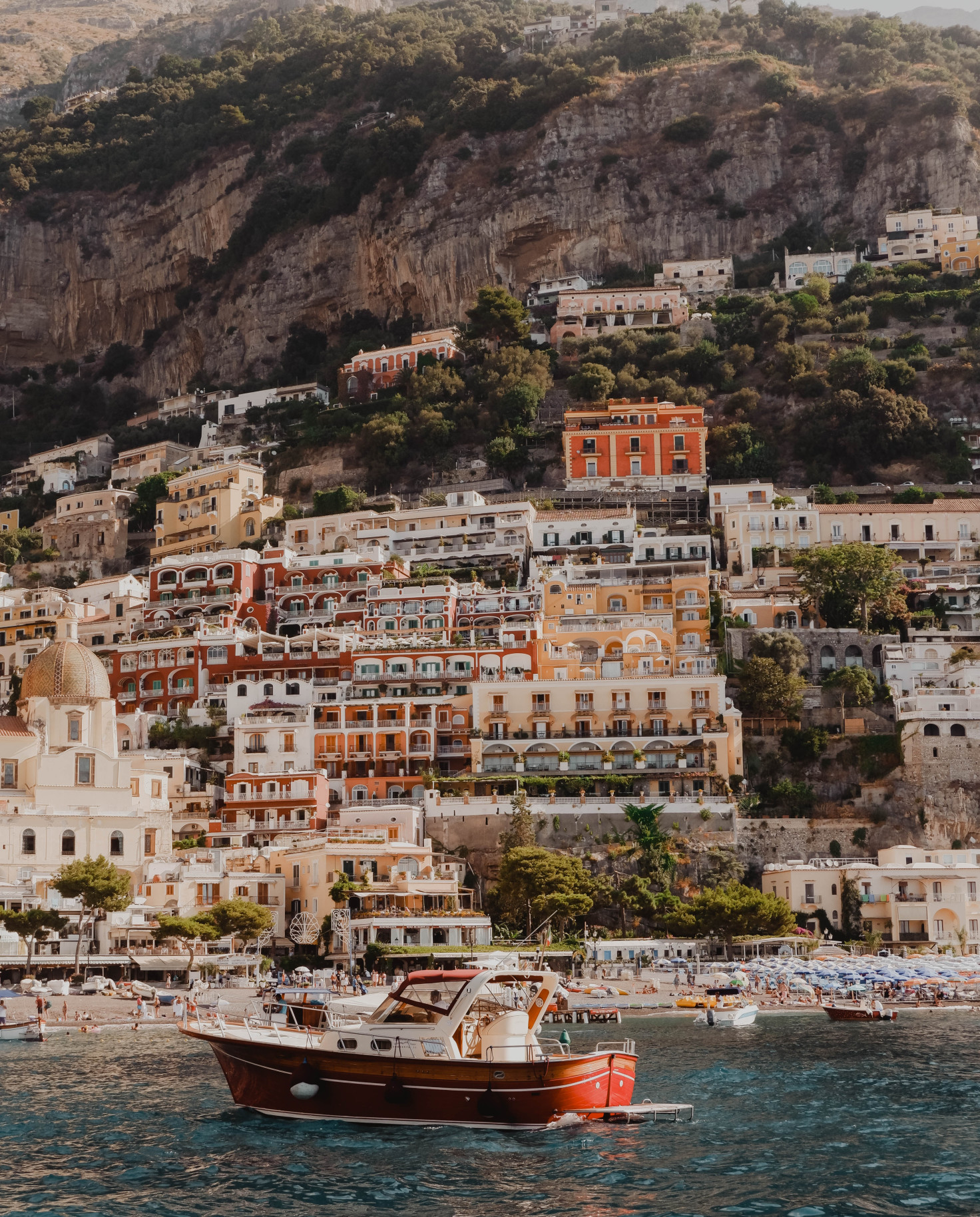 Boat in the water with buildings in the background in Positano, Italy