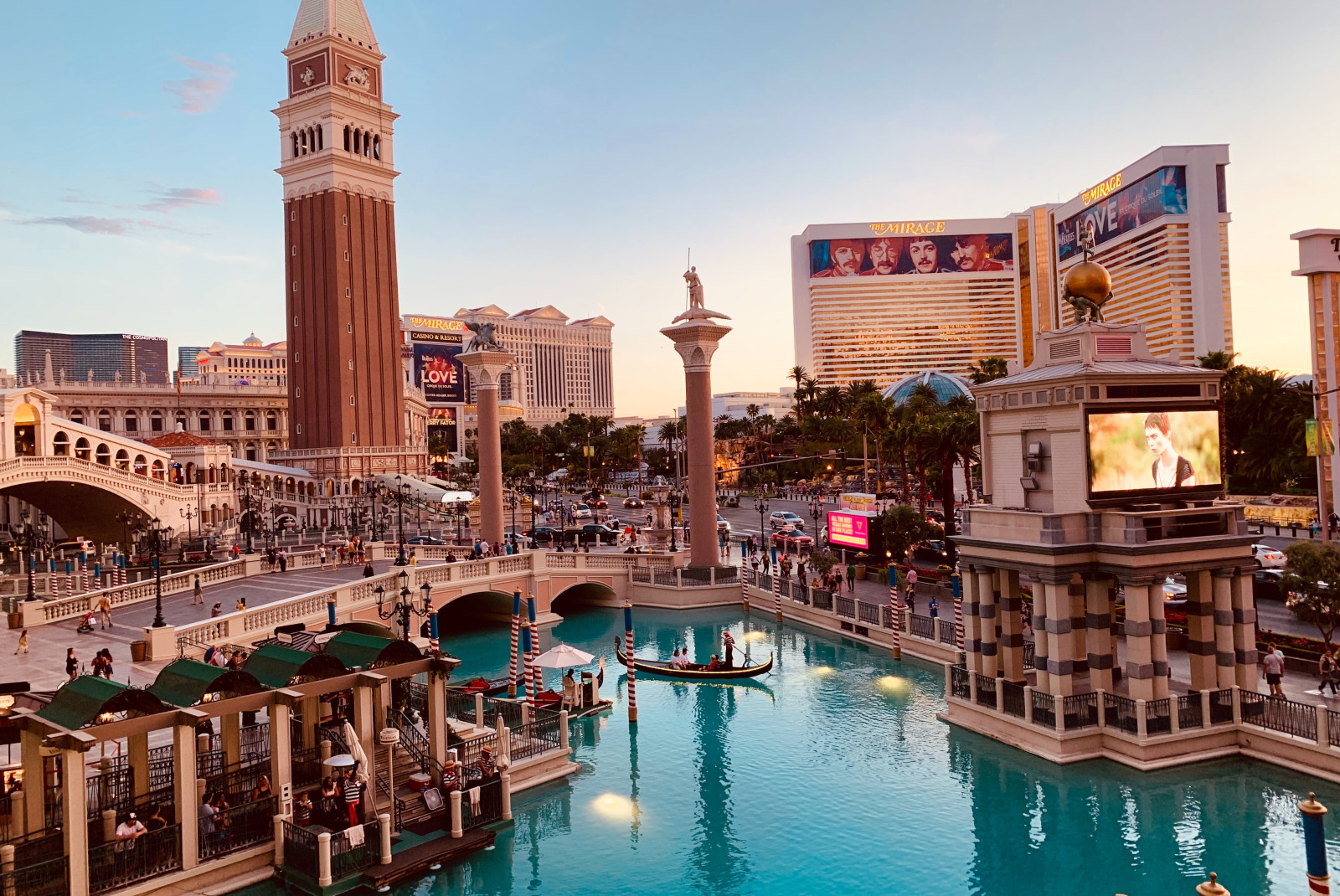 las vegas nevada strip with brown and white buildings and blue water with gondola boats 