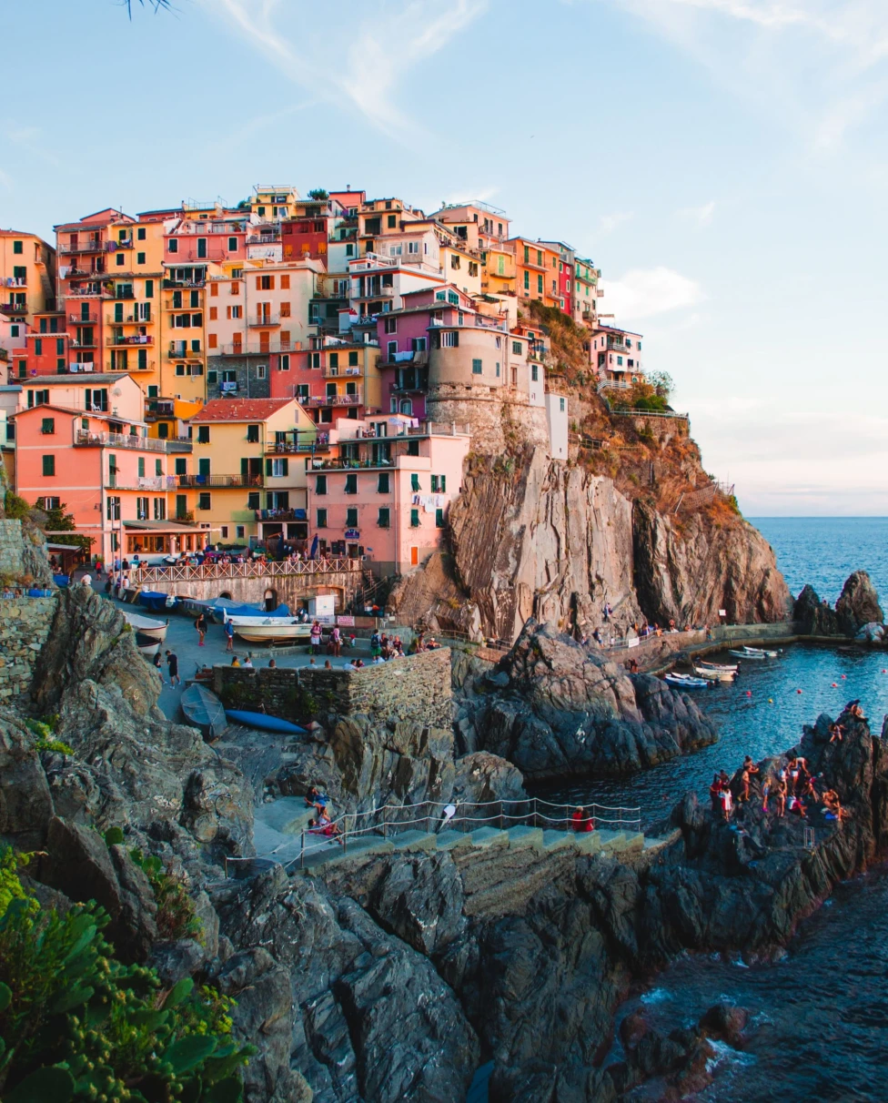 a colorful city perched atop the hillside of an island