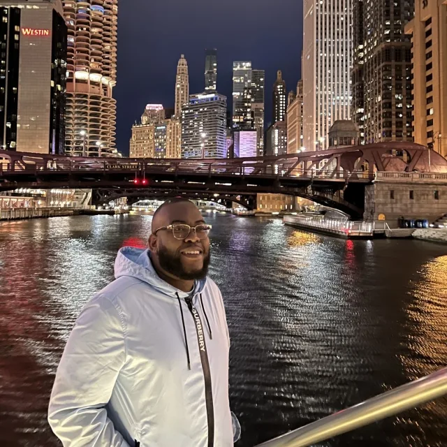 Travel advisor Huntley Sawyers stands in front of the Chicago River.
