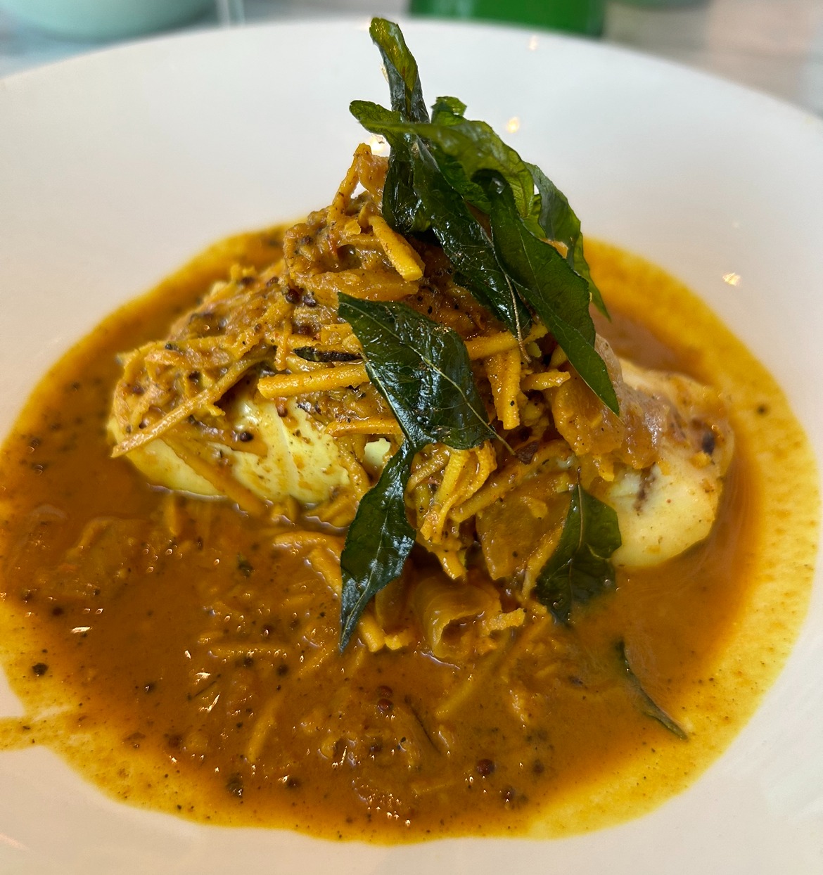 a plate of spaghetti in a curry sauce