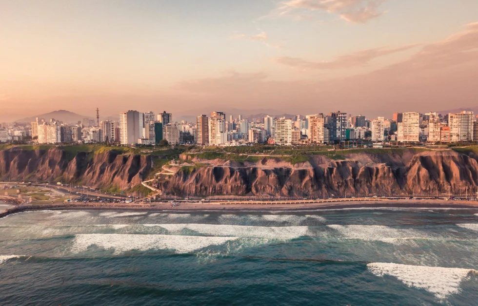 City of Lima beside the ocean during sunset.