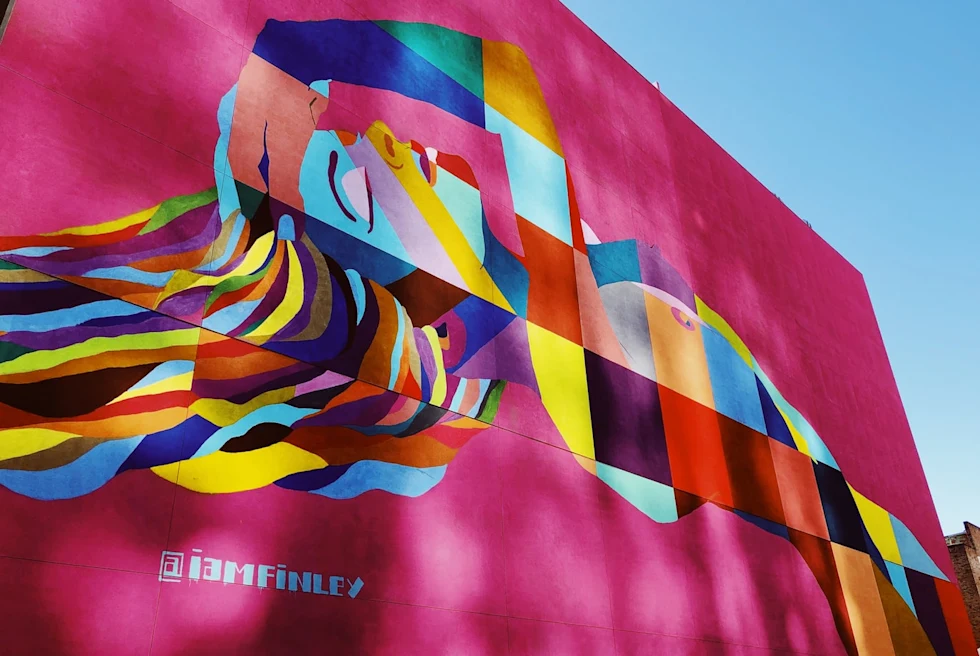 street art in los angeles on pink wall woman multi colored