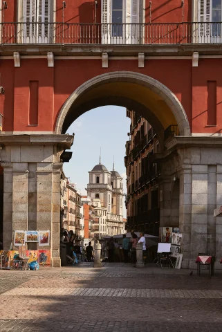 An antique building with street vendors in Madrid. 