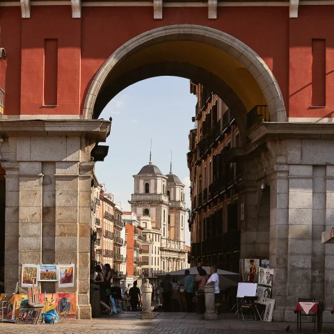 An antique building with street vendors in Madrid. 