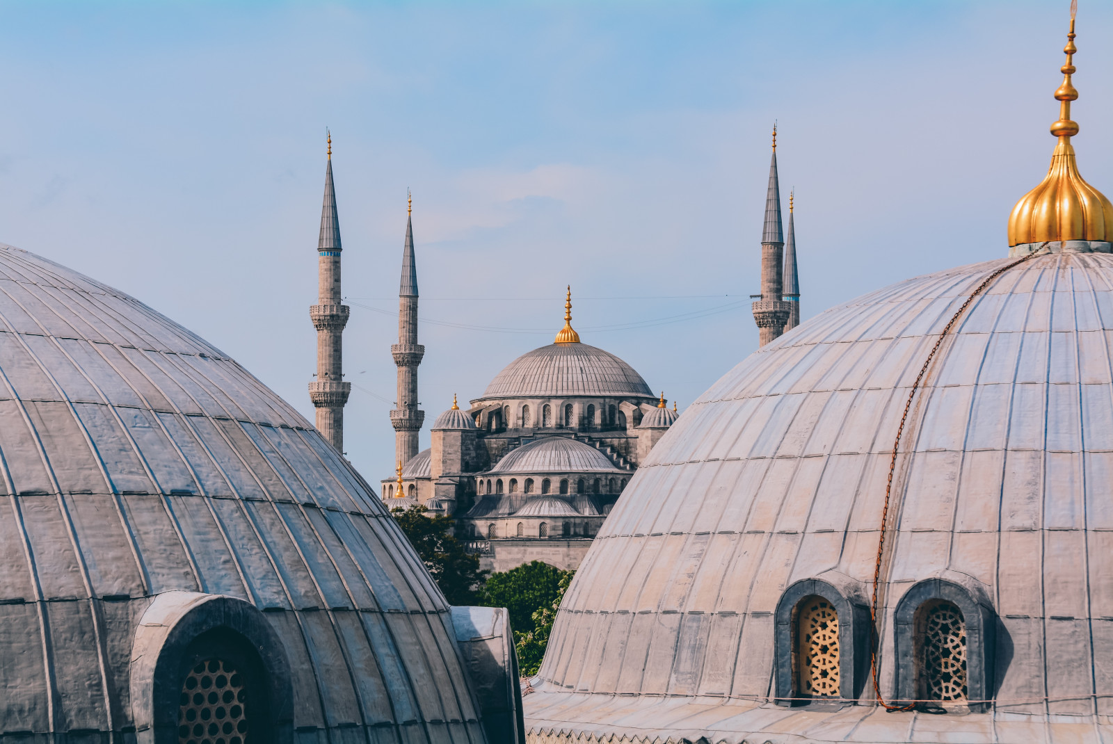 Circular buildings with grey roofs and gold pointed toppers in Istanbul