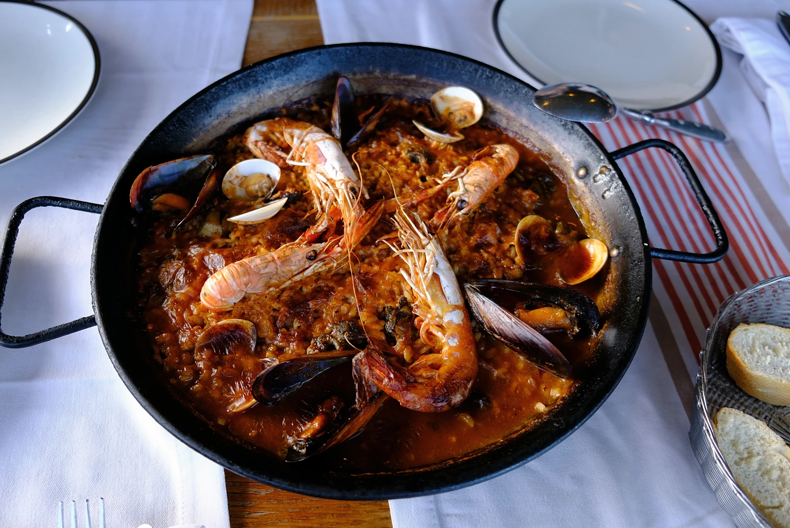 Seafood dish in black pot on table in Seville, Spain