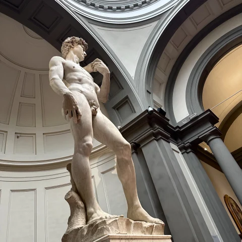 Statue of a naked man inside a museum. 