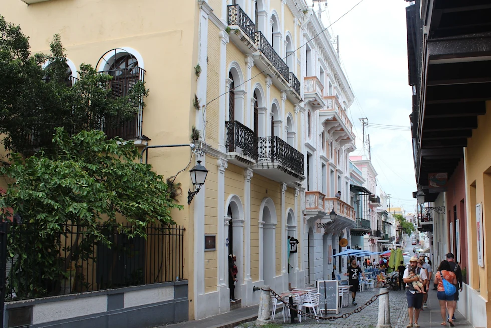 colorful houses and restaurants line narrow long street