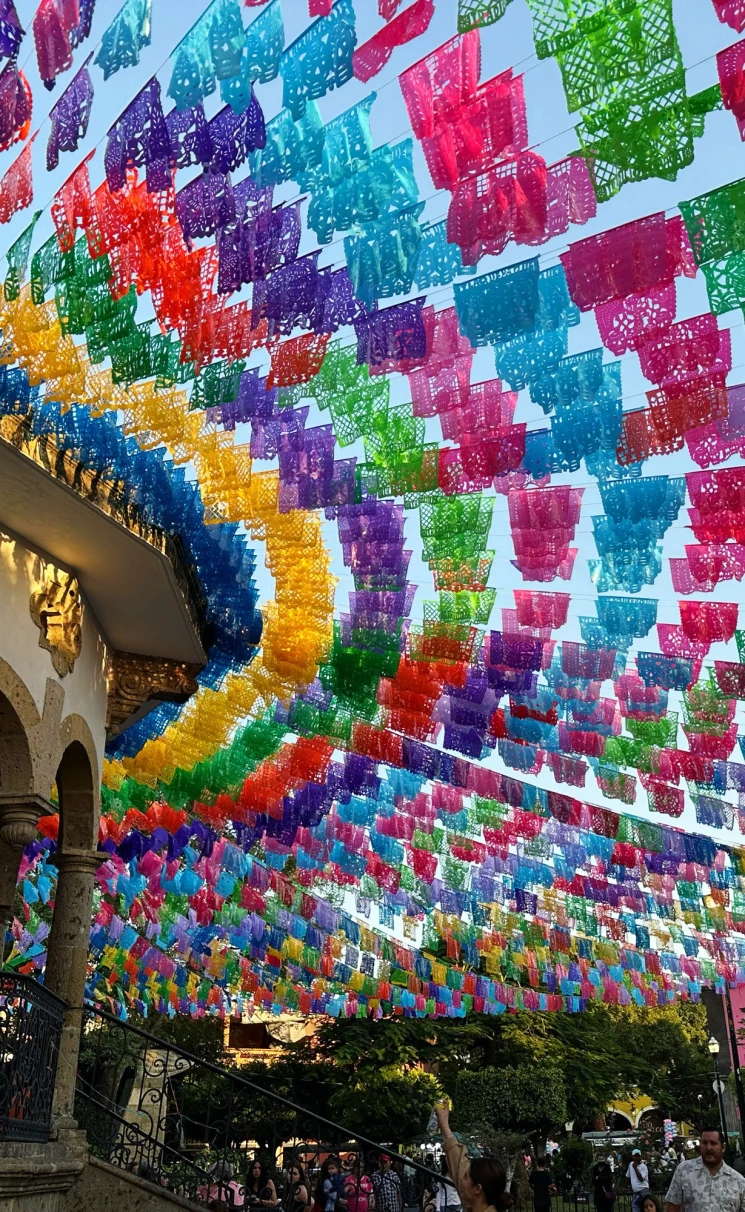 color flags strung through the air over a busy market