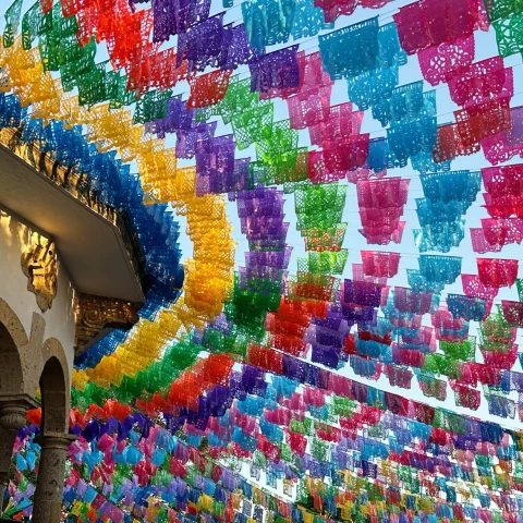 color flags strung through the air over a busy market