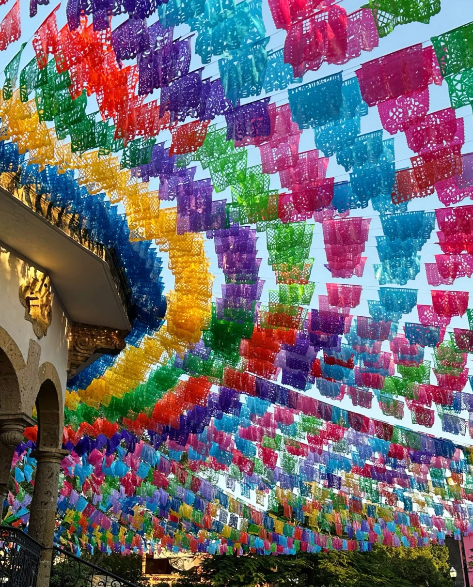 color flags strung through the air over a busy market