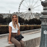 Blond woman smiling with ferris wheel in background