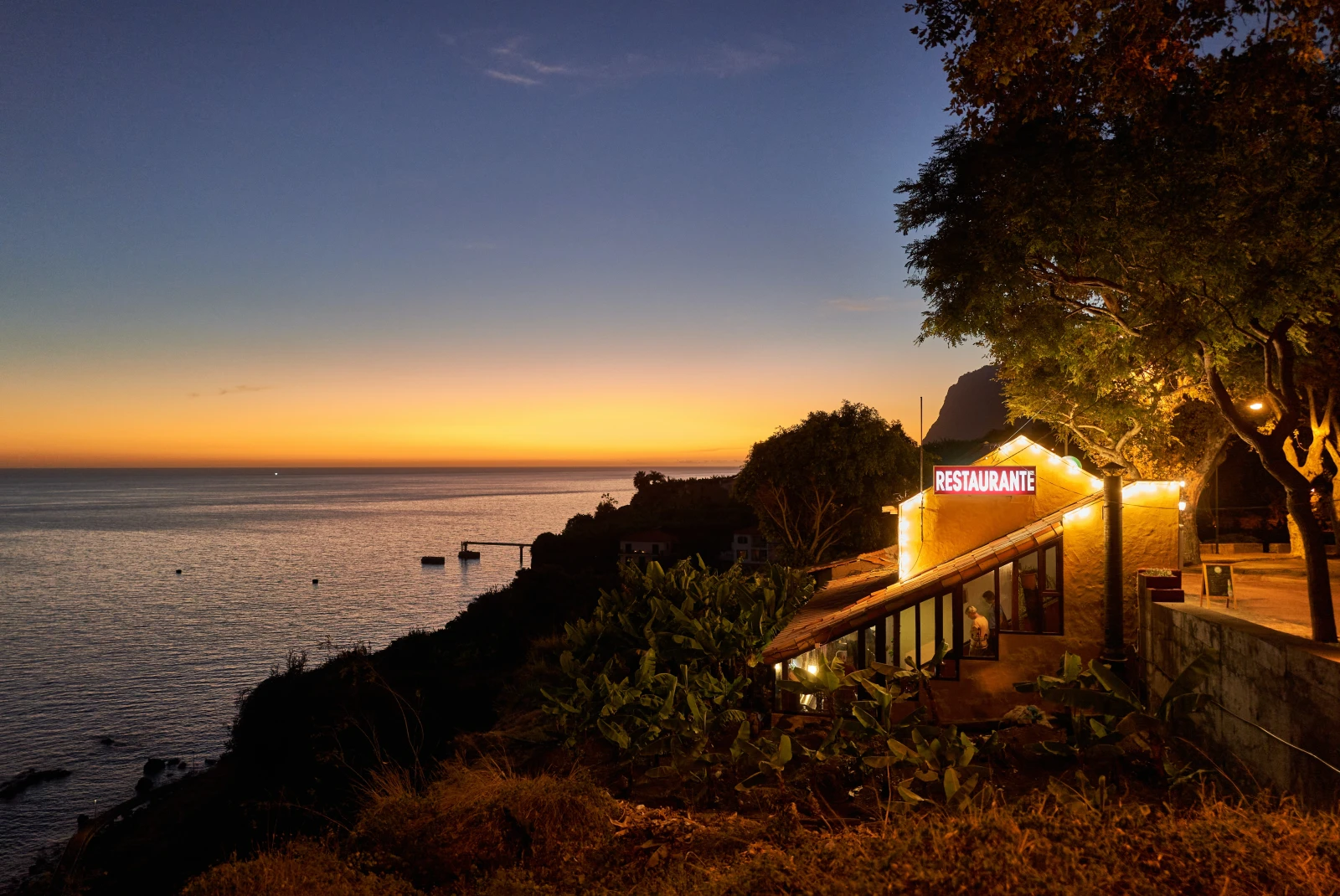 Restaurant at sunset on an island. 