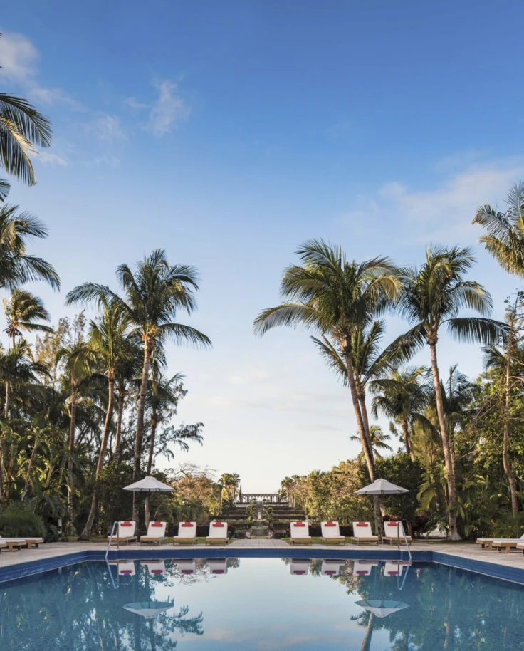 The 8 Best Hotels in the Bahamas - The Four Seasons Ocean Club located on the north shore of Paradise Island. The Four Seasons Ocean Club's pool surrounded by lush palm trees.