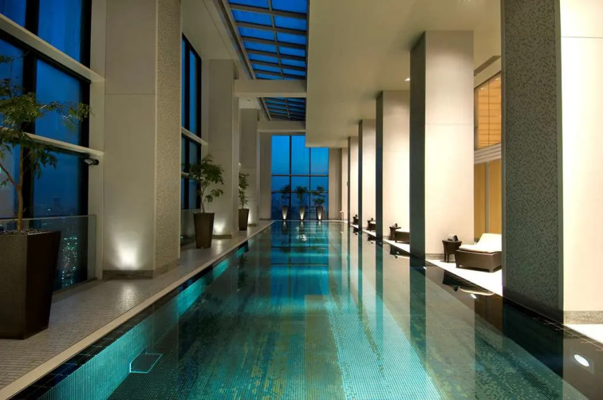 an indoor pool surrounded by large pillars