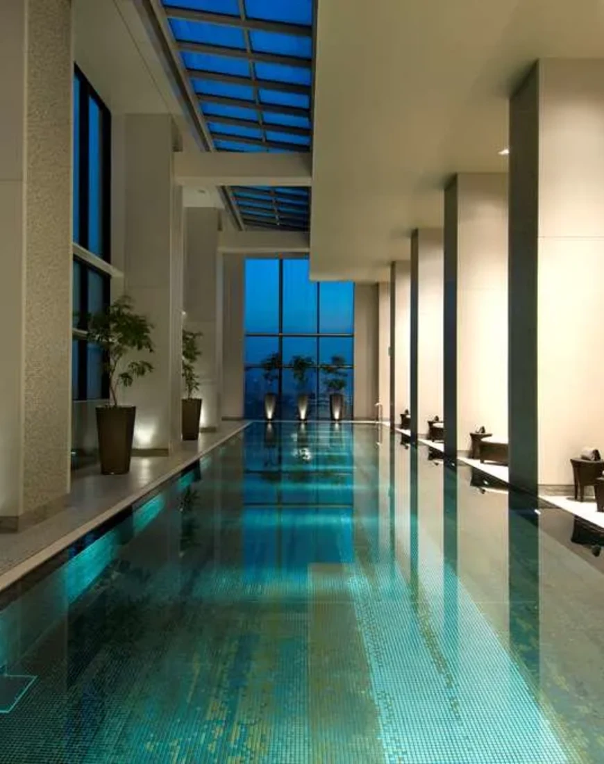 an indoor pool surrounded by large pillars