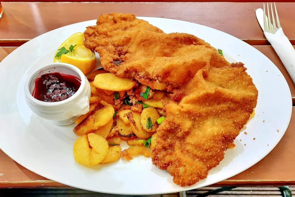 Schnitzel on a white plate with potatoes