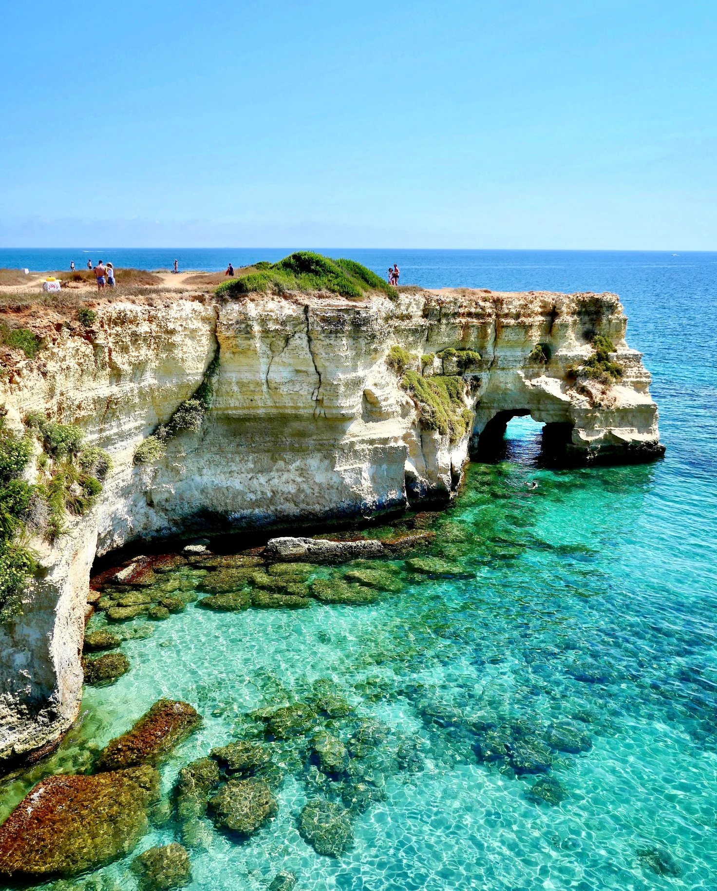 Puglia aerial coastal views with blue waters and rugged rocks. 