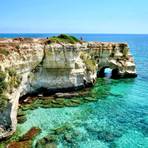 Puglia aerial coastal views with blue waters and rugged rocks. 
