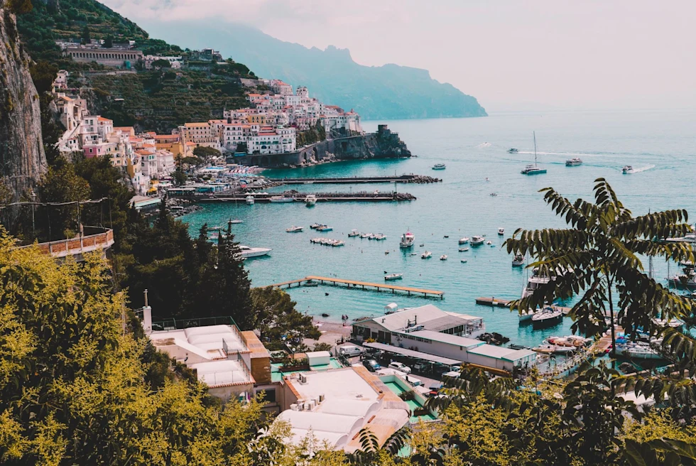 Ocean with boats and buildings around.
