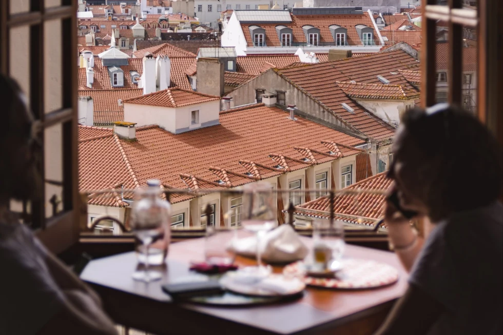 open window overlooking the tiled rooftops of Lisbon