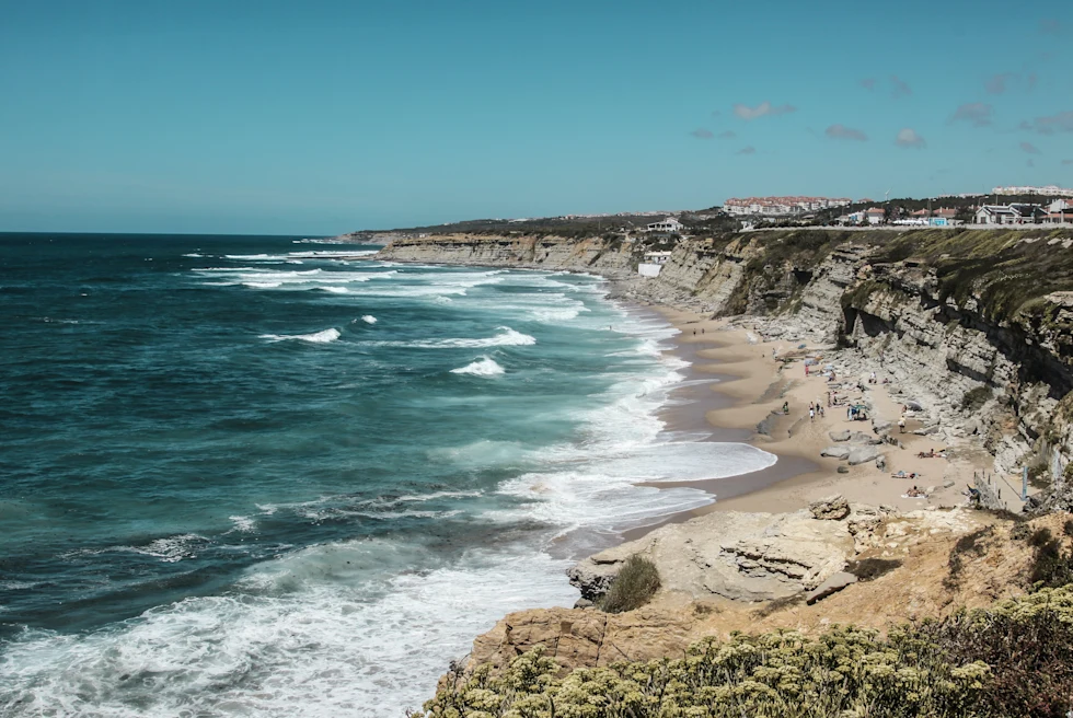 body of water next to rocky coast during daytime