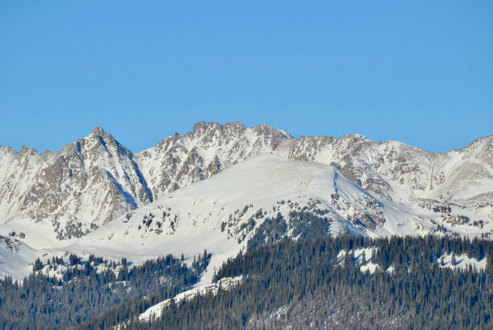 snowy mountains with blue skies