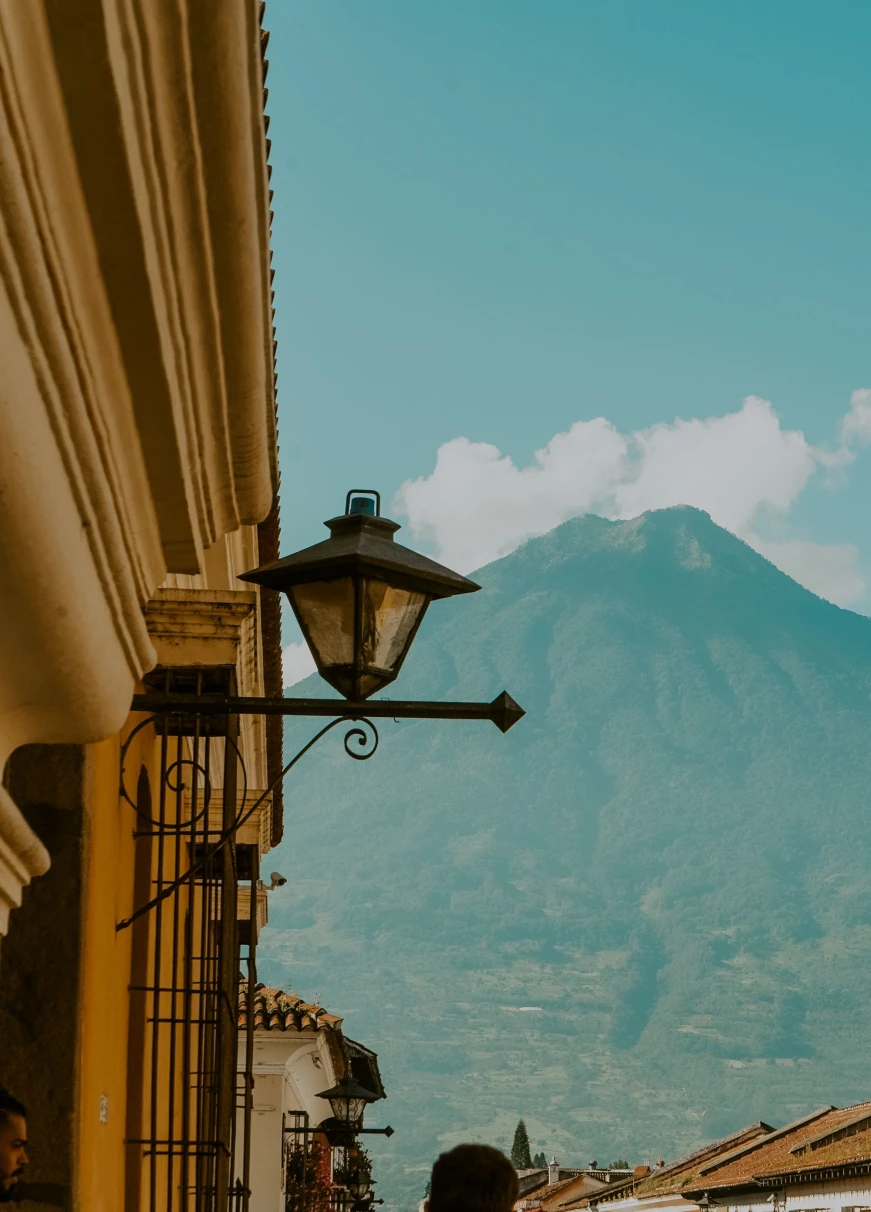 a street lamp with a mountain in the distance
