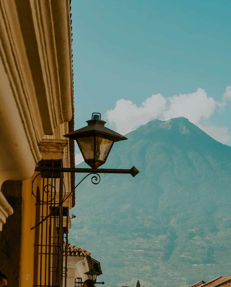 a street lamp with a mountain in the distance