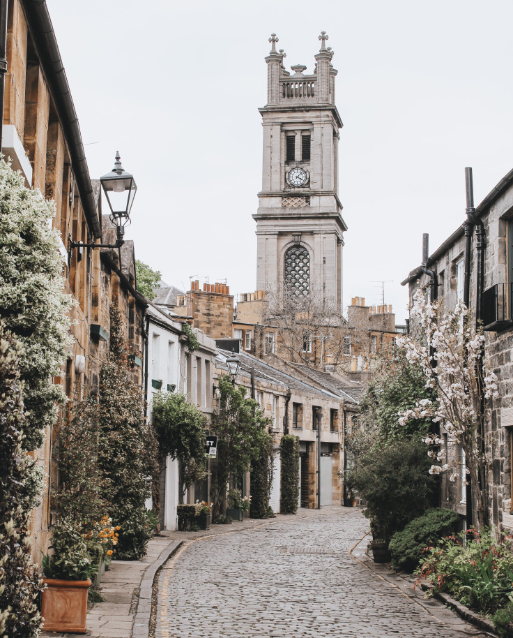 Cobblestone street leading to tower on a cloudy day